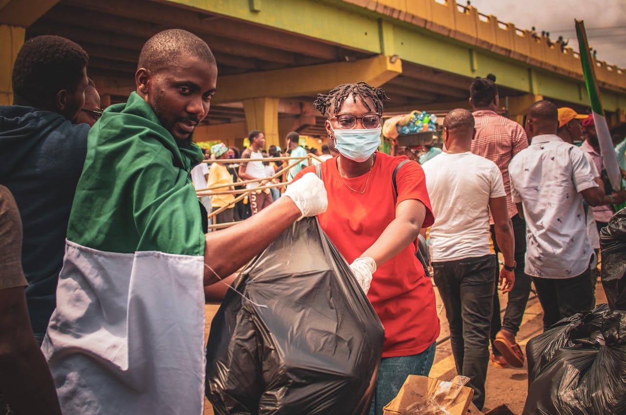 Group participating in community cleanup under an urban bridge, promoting environmental conservation.